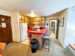 Mammoth Lakes Vacation Rental Chamonix A7 - Kitchen Bar and Entrance Bedroom and Bathroom Area